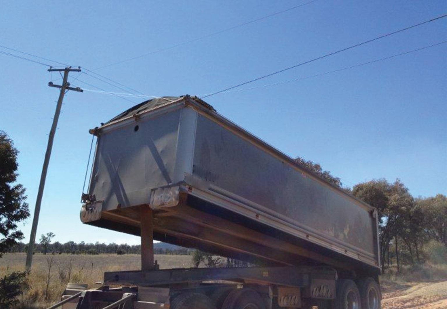 Tipper truck near powerline